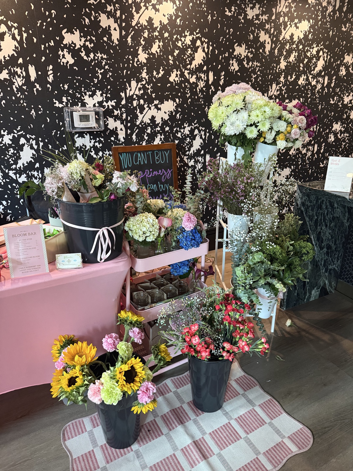 Bloom bar display filled with buckets of colorful flowers
