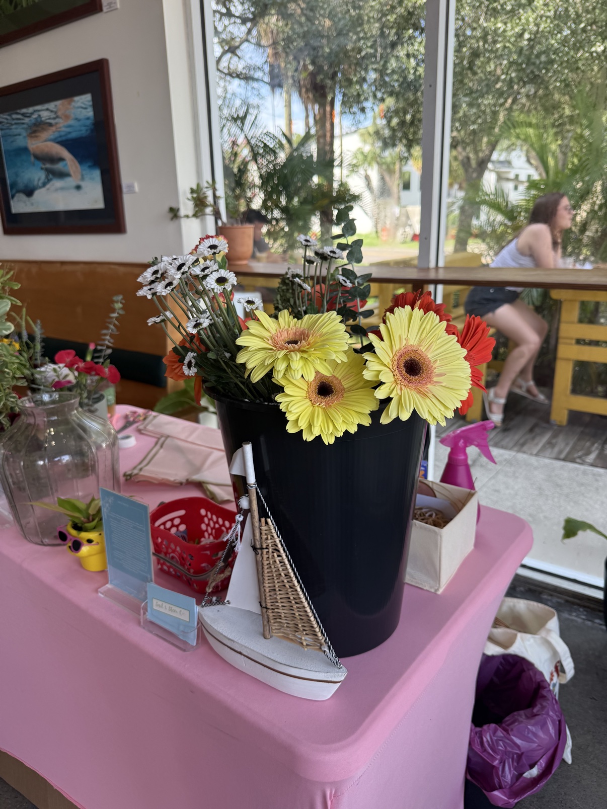 Sunflowers and daisies arranged on a pink bloom bar cart