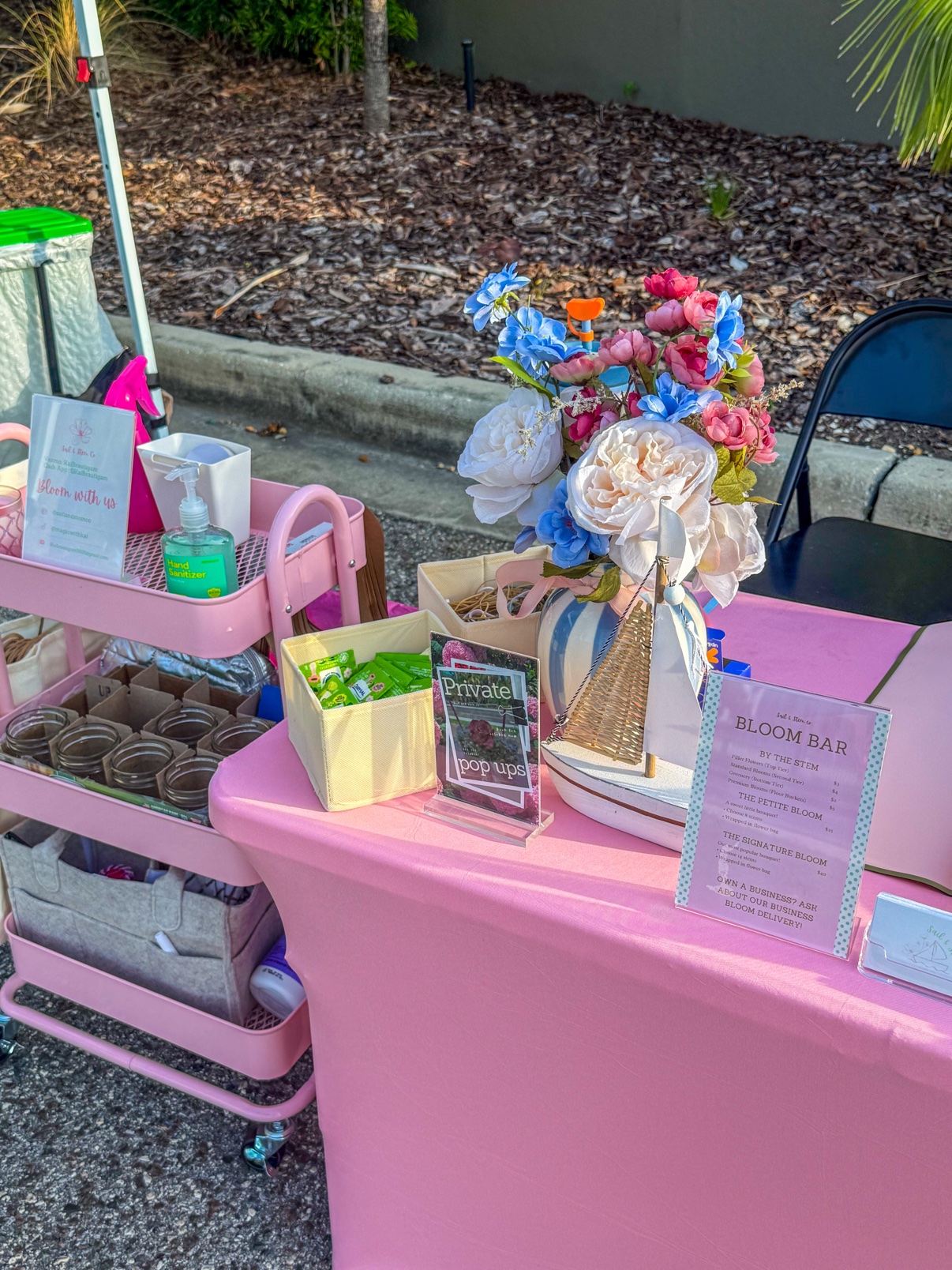 Outdoor bloom bar setup with accessories and a bright mixed bouquet
