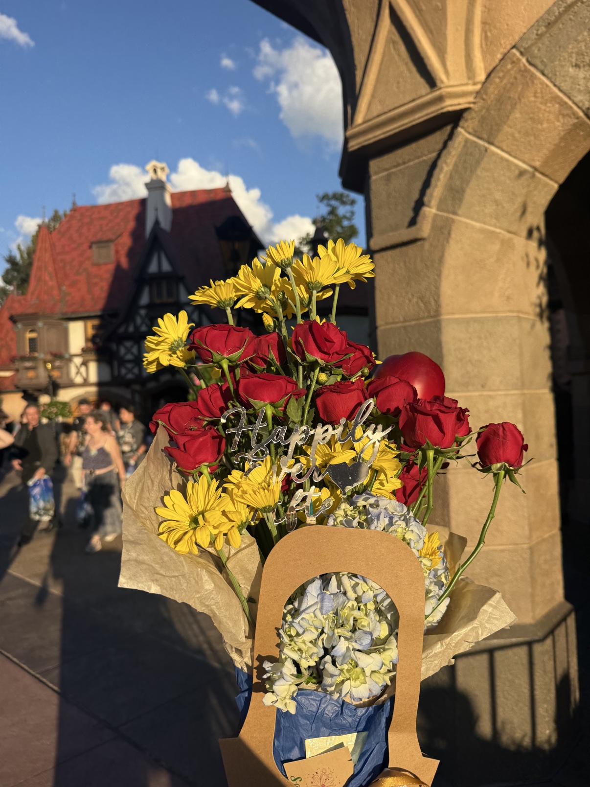 The Fairest One bouquet in a stone archway at EPCOT's Germany pavilion in golden light
