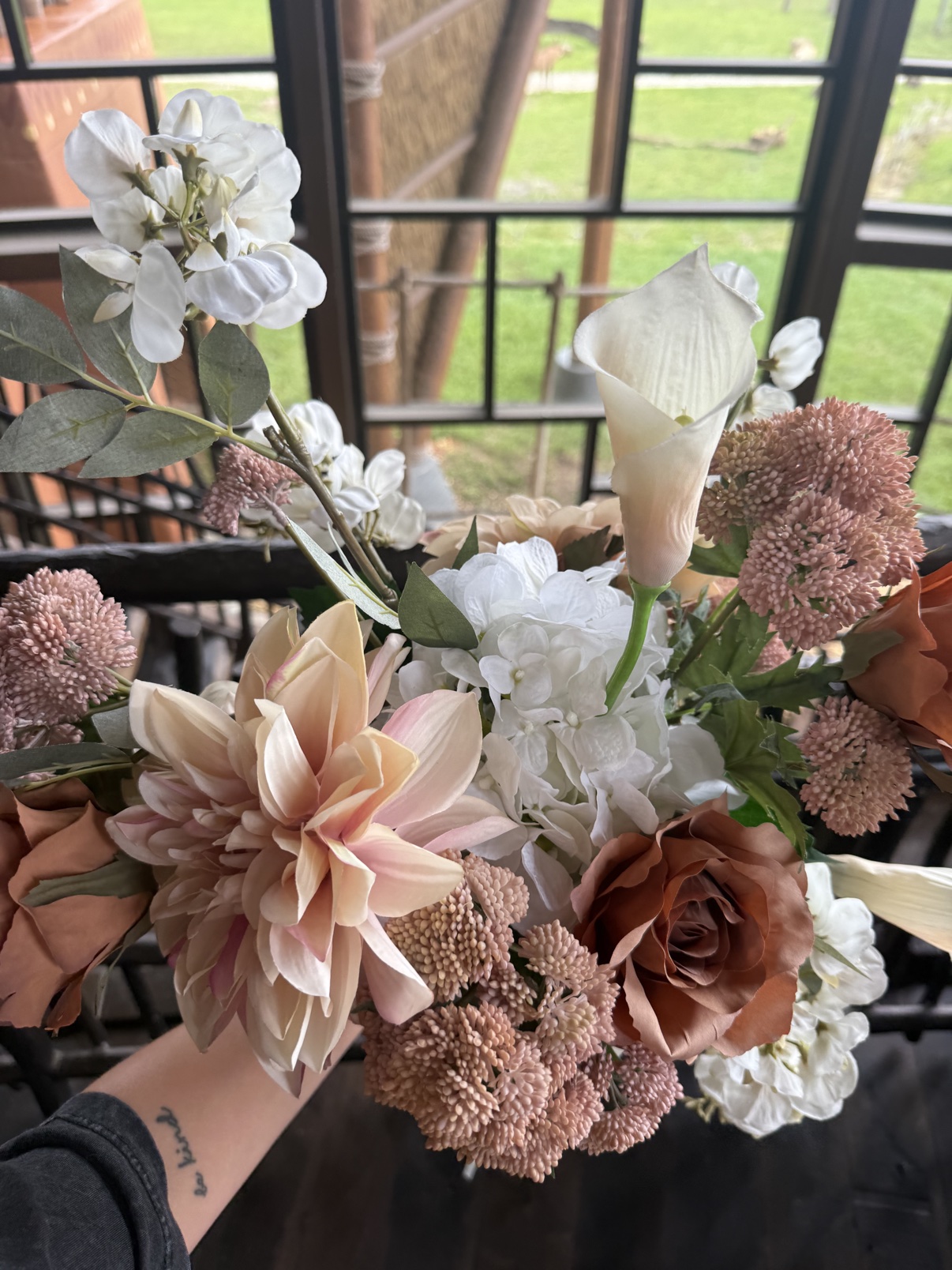 Close-up of the custom faux Victorian Grande bouquet with a blush dahlia, white calla lily, and dusty-rose accents at Disney's Animal Kingdom Lodge